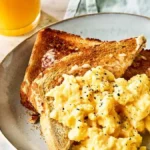 Classic scrambled eggs garnished with pepper and parsley