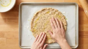 Can Chicken Pizza Crust Recipe: The Viral Low-Carb Pizza Americans Are Loving 16 Shaping chicken pizza crust mixture into a round crust on parchment paper
