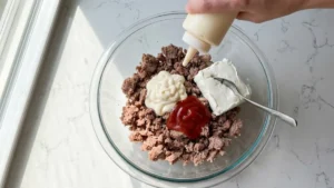 Braunschweiger Dip Recipe 15 Mayonnaise, ketchup, and cream cheese added to braunschweiger in a bowl.