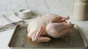 Whole Pheasant Recipes 16 Whole pheasant resting uncovered on a rack to air dry before cooking