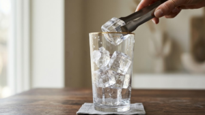 Don Julio Paloma Recipe 5 Adding ice cubes to cocktail glass