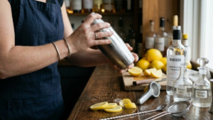 Lemon Drop Recipe 17 Cocktail shaker being shaken with ice to mix a lemon drop cocktail