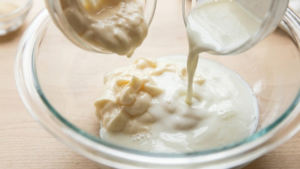 Mazzio’s Ranch Recipe 15 Mayonnaise and buttermilk being added to a bowl