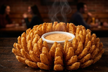 Texas Roadhouse blooming onion crispy cactus blossom with golden petals and spicy dipping sauce close-up